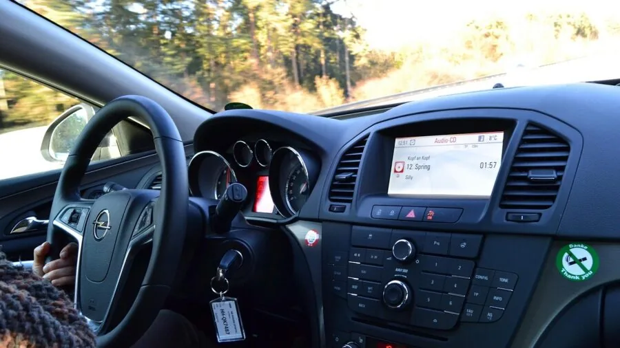 Driver gripping steering wheel in hot car interior showing comfort and control during summer driving
