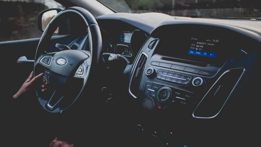 Driver viewing responsive dashboard display after engine startup in modern vehicle interior