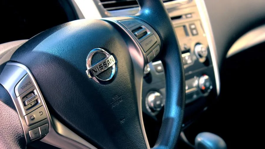 Driver's hands on steering wheel inside vehicle, showing car interior lifestyle scene