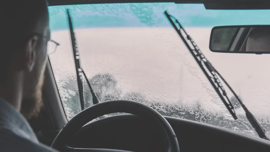 Driver's perspective through car windshield while driving on road during daytime