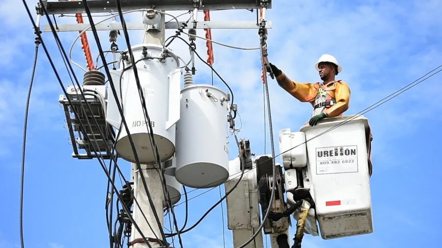 Electrician inspecting residential electrical panel and circuit breakers during home installation work