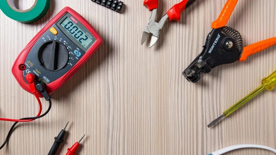 Electrician using voltage detection tool on electrical wiring without direct contact