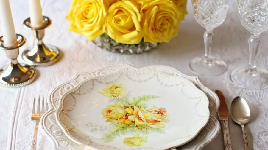 Elegant formal dinner table setup with place settings and glasses ready for guests