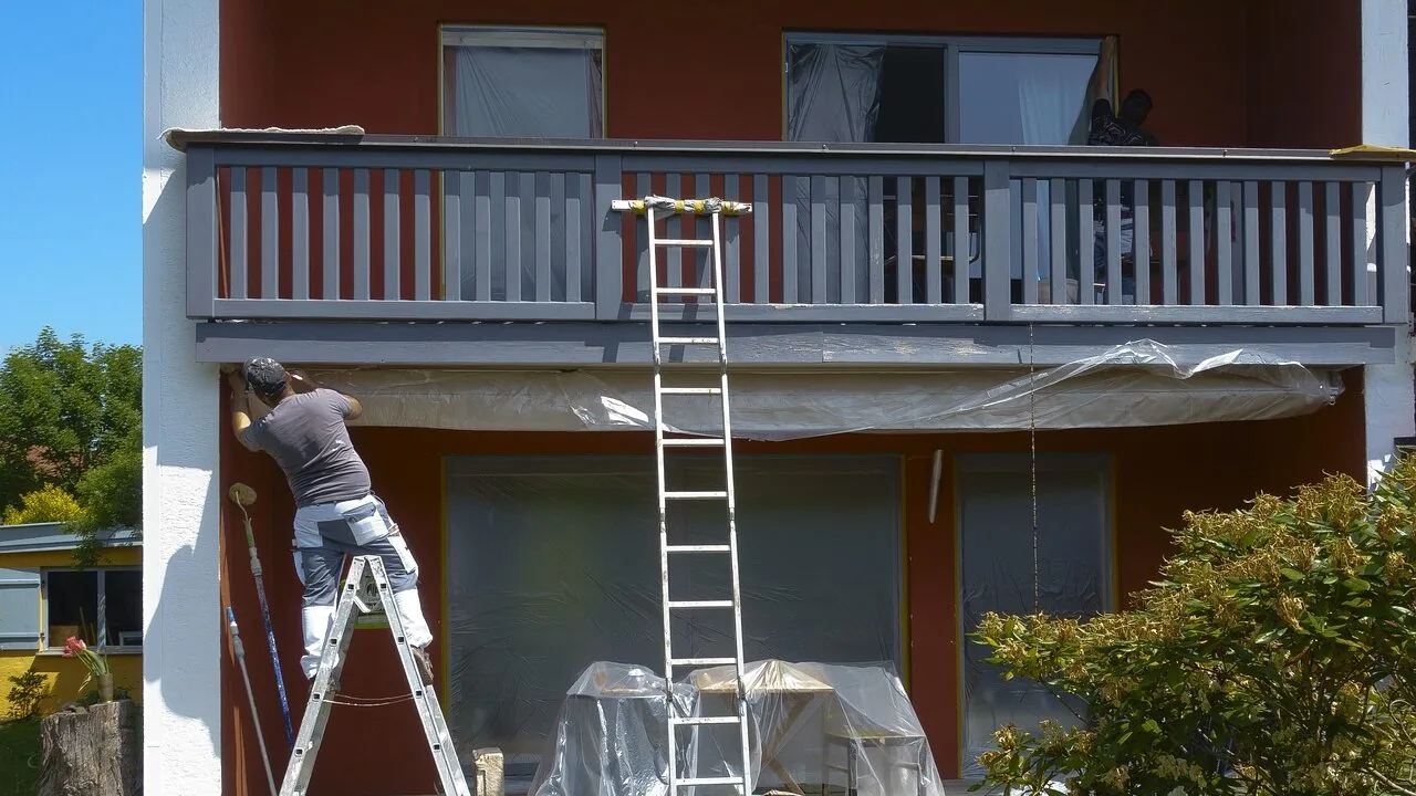 Extension ladder extended against exterior house wall in natural daylight