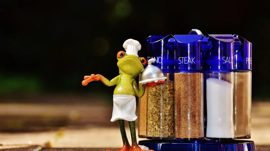 Family cooking together at a campsite with camping gear and natural surroundings