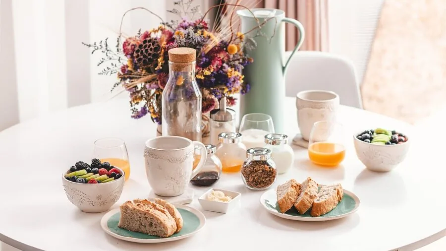 Family enjoying a meal together at a dining table with colorful dinnerware and food