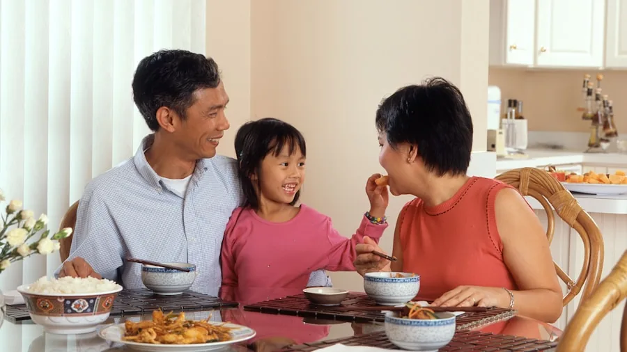 Family enjoying a warm rice bowl meal together at the dining table
