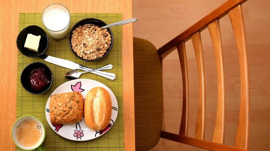 Family enjoying dinner together at a wooden table with comfortable upholstered dining chairs