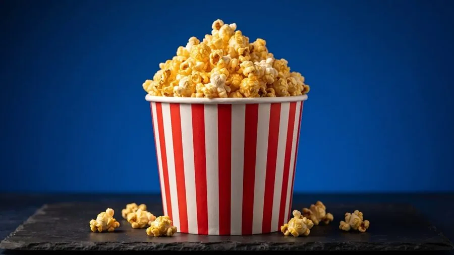 Family enjoying popcorn together during a cozy movie night at home