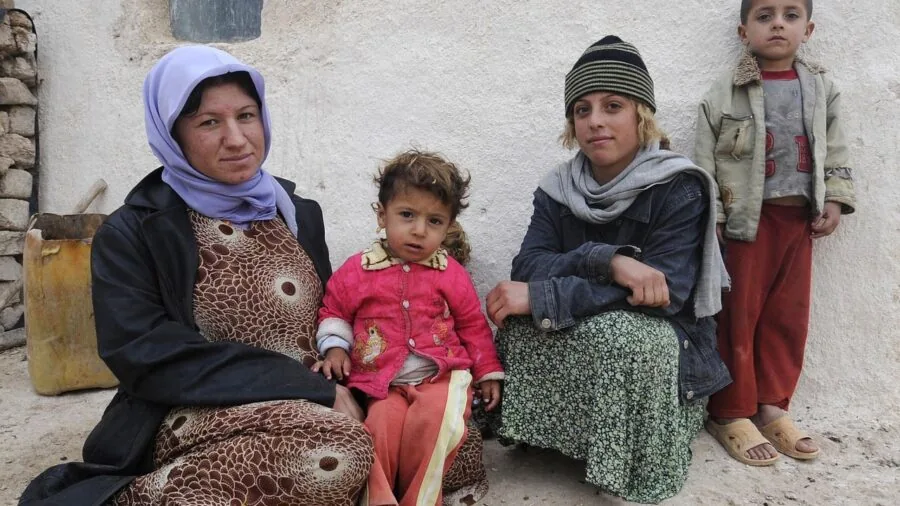 Family enjoying warm outdoor patio gathering during evening with protective heater nearby