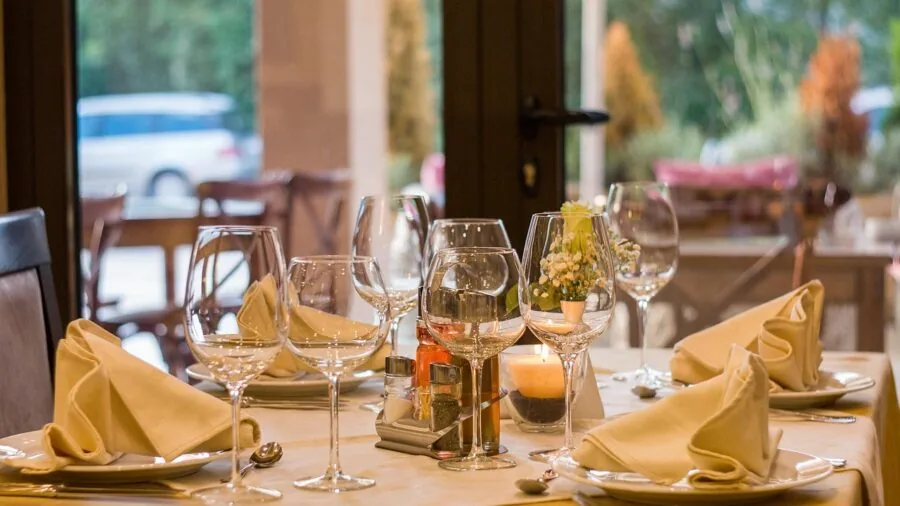 Family gathered around dining table for meal, discussing dinnerware options and value