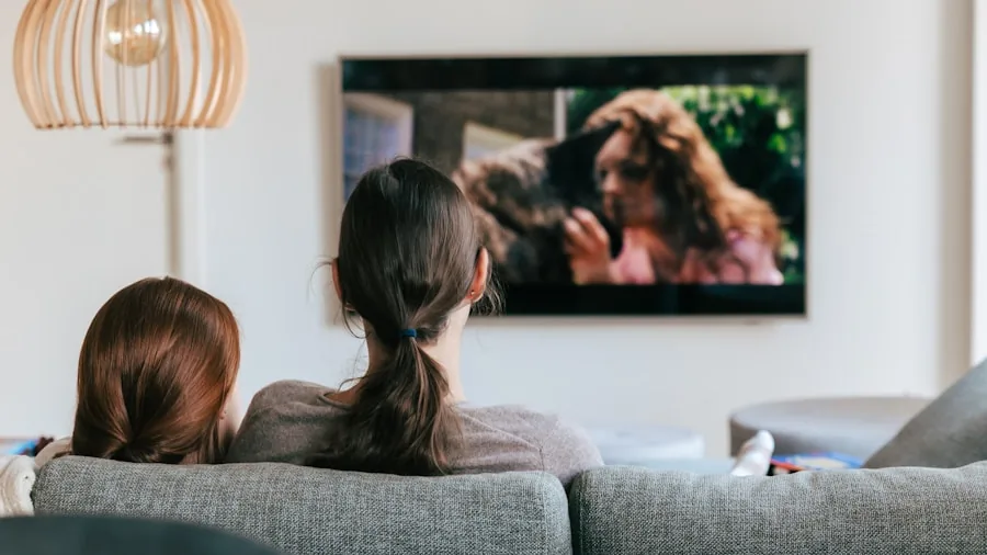Family gathered in living room watching TV together, enjoying entertainment on a large screen display