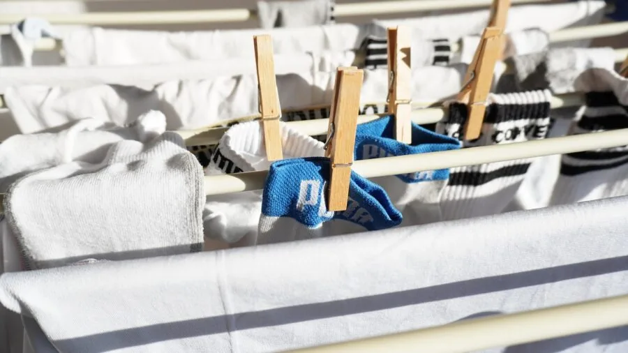 Family laundry basket filled with clean clothes and linens in a home setting