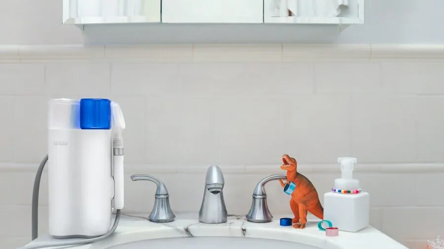 Family members brushing teeth together at bathroom sink during morning routine