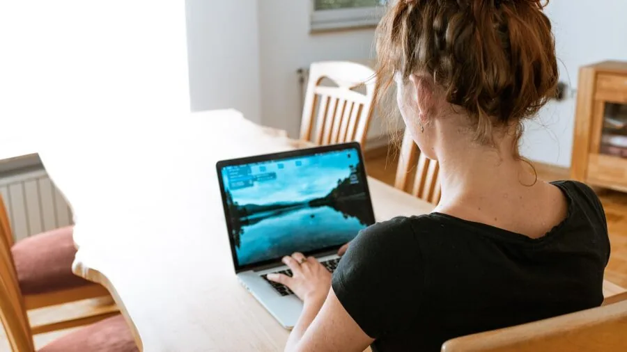 Family members on video call in modern living room with multiple devices connected