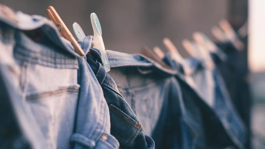 Family members sorting and organizing clothes into laundry baskets at home