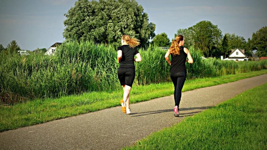 Female athlete jogging outdoors during workout session in natural daylight