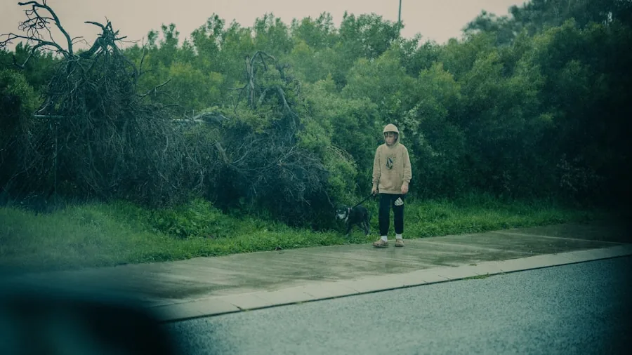 Female runner jogging on wet street during rainy weather conditions