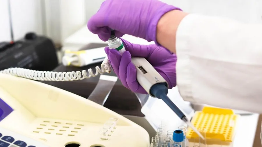 Female scientist in professional attire working in modern laboratory setting
