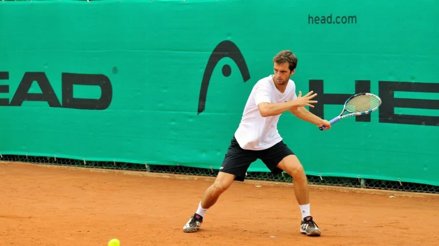 Female tennis player demonstrating stretching and movement on court during training session