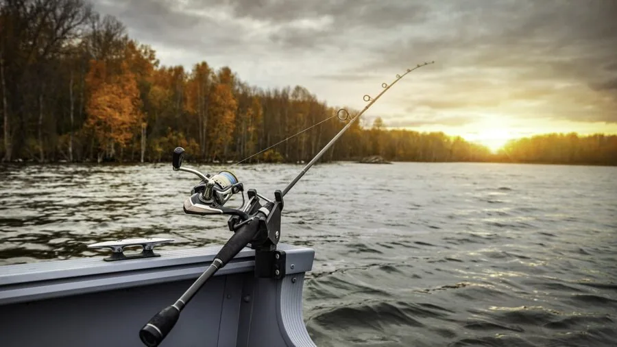 Fisherman examining spinning rod blank details and weight ratings before casting
