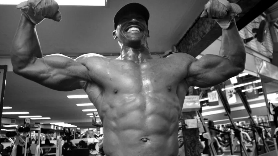 Focused athlete performing intense strength training workout in modern gym facility