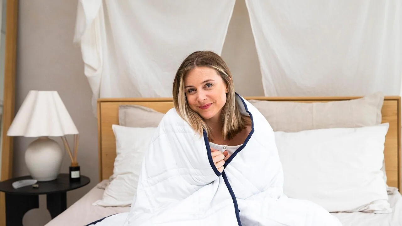 Folded linen sheets displayed on a bed with natural lighting