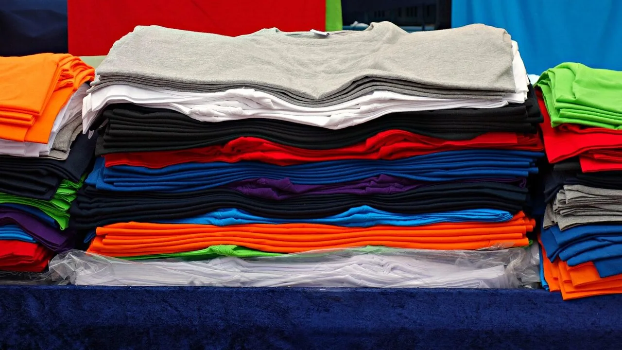 Folded men's casual button-down shirts in various colors displayed together