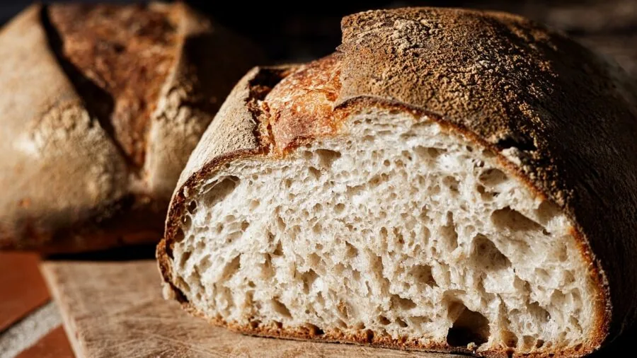 Fresh loaf of bread on a kitchen counter in natural morning light, emphasizing food freshness and storage