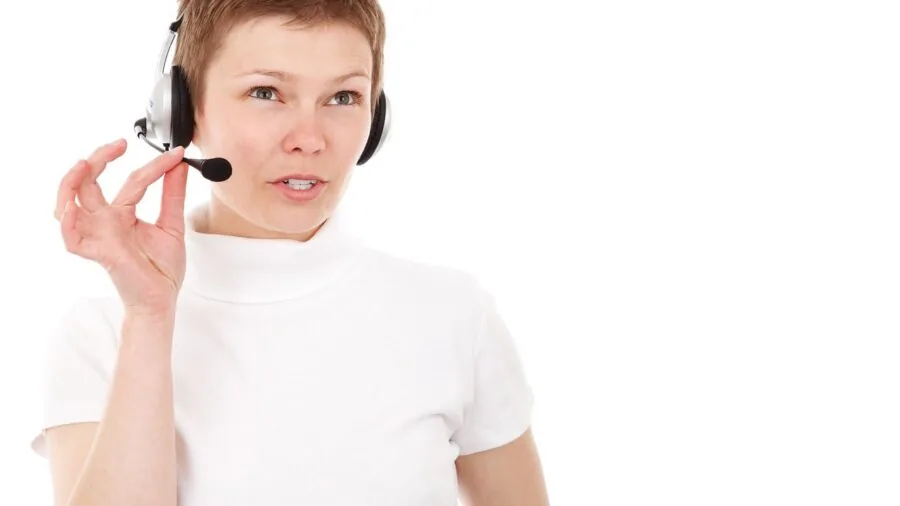Gamer wearing headset speaking into microphone during online gaming session