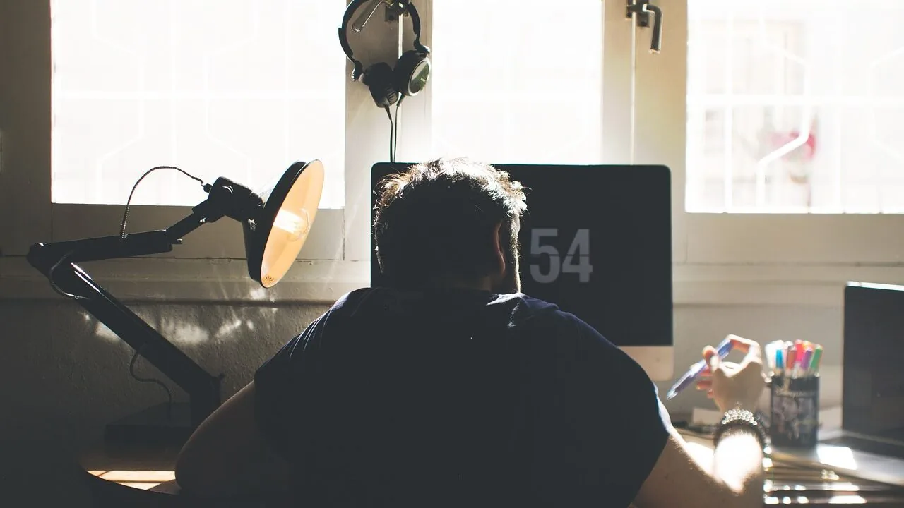 Gaming chair with ergonomic design positioned at computer desk with monitor