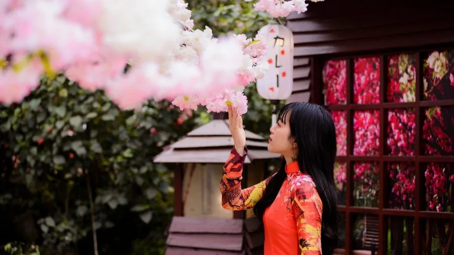 Gardener maintaining outdoor statue with care and attention in natural setting