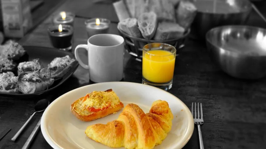 Glass of fresh orange juice on a bright kitchen counter with whole oranges nearby