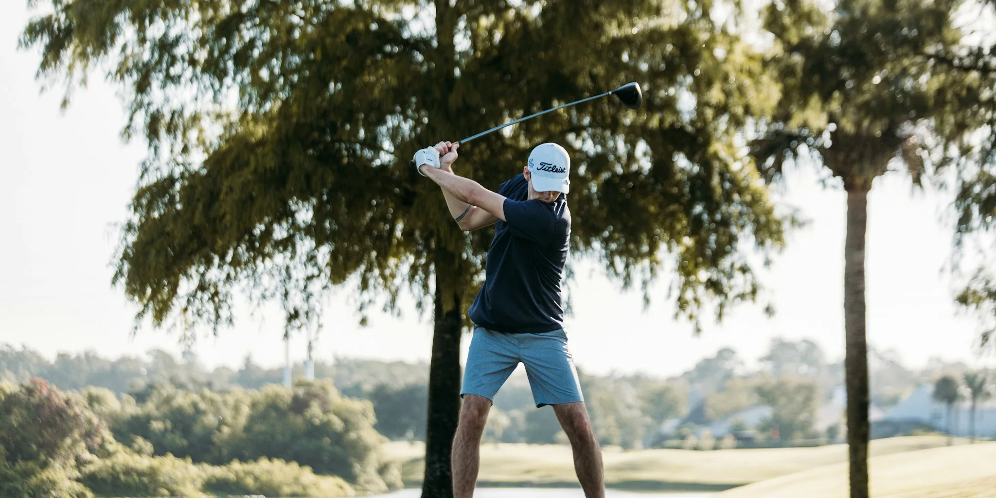 Golf driver club head on grass course with clear focus on club design