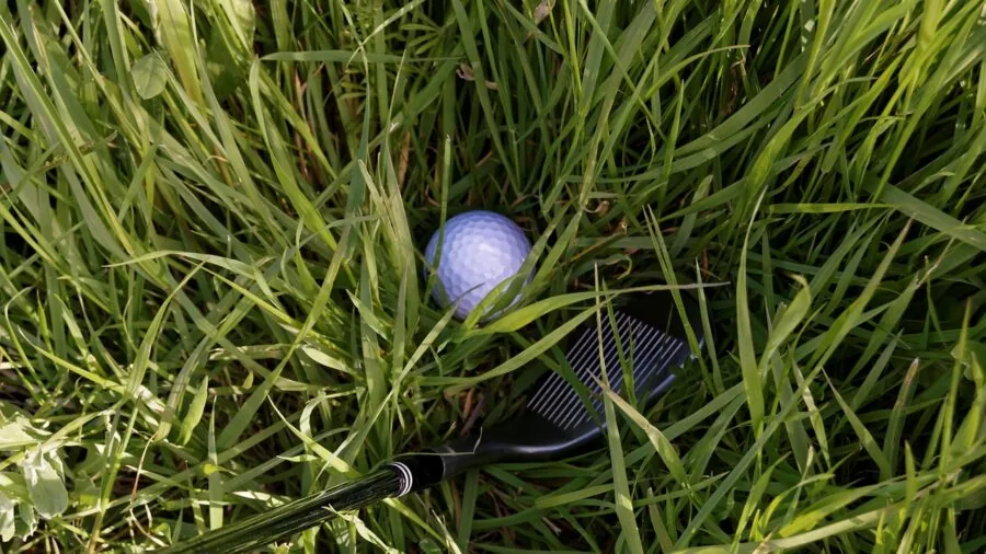 Golfer carefully placing golf rangefinder into protective case on course