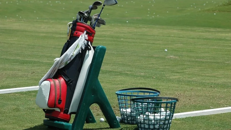 Golfer customizing and adjusting golf driver settings before taking a shot on fairway