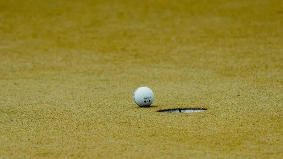 Golfer demonstrating swing mechanics and launch angle technique on golf course