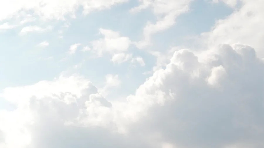 Golfer in dry conditions swinging on sunny course with clear skies