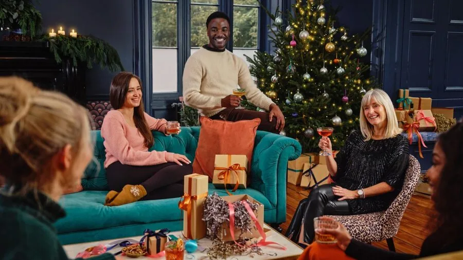 Group of friends playing video games together on a TV in a cozy living room setting