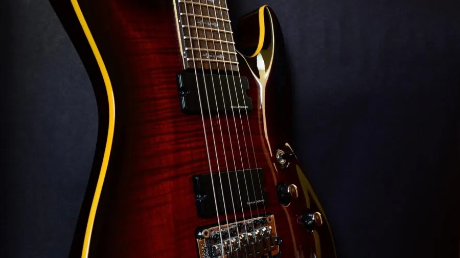Guitarist's hands adjusting knobs on guitar pedal controls during live performance setup