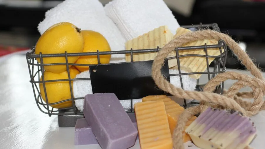 Handmade colorful soap bars with botanical elements and natural ingredients displayed in lifestyle setting