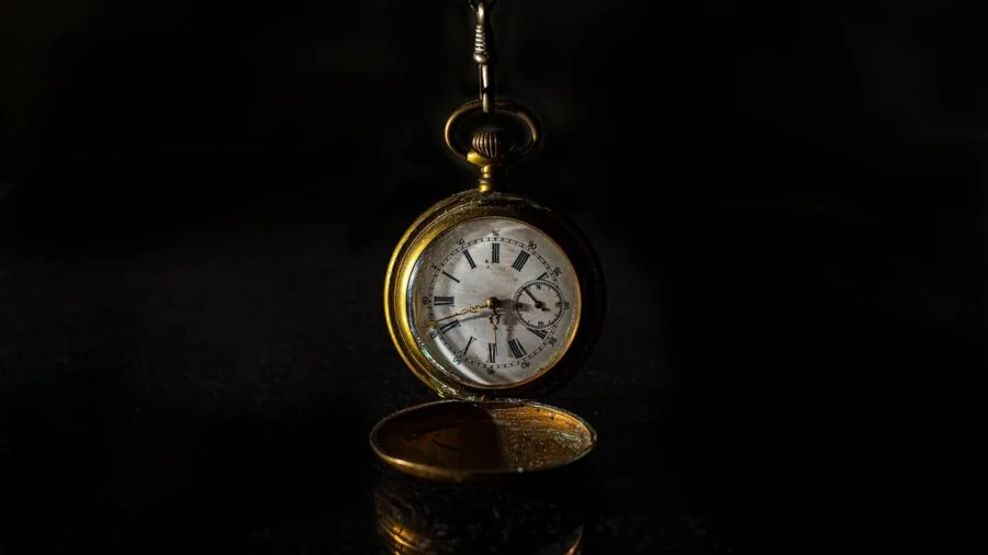 Hands holding an antique pocket watch across generations, symbolizing heritage and timeless value