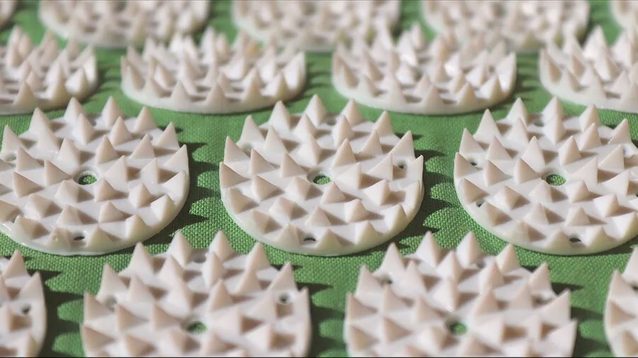 Hands working on a self-healing cutting mat during a creative crafting project