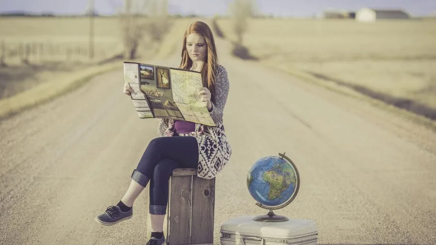 Happy child standing with personalized luggage ready for family travel adventure