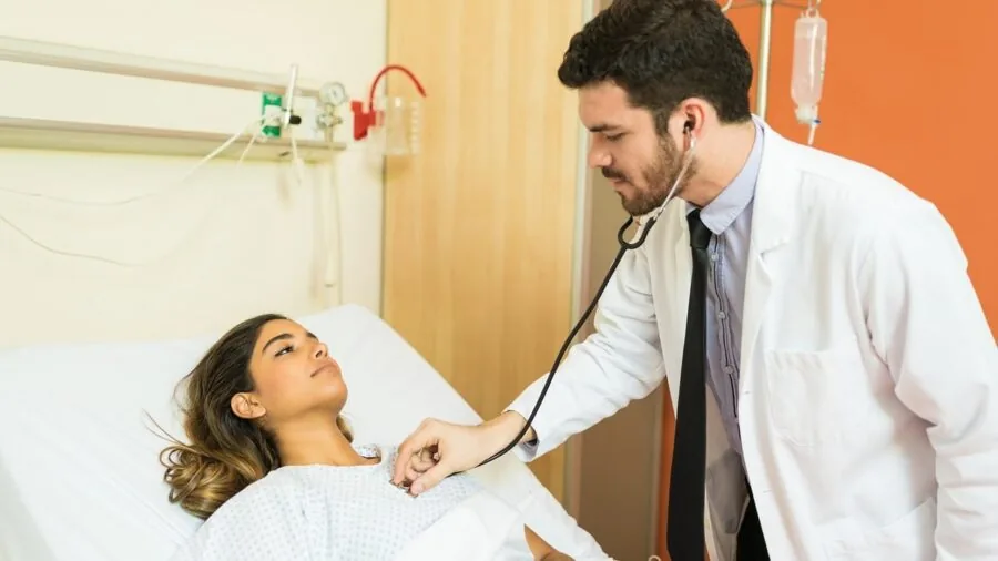 Healthcare professional examining patient's ear during medical consultation