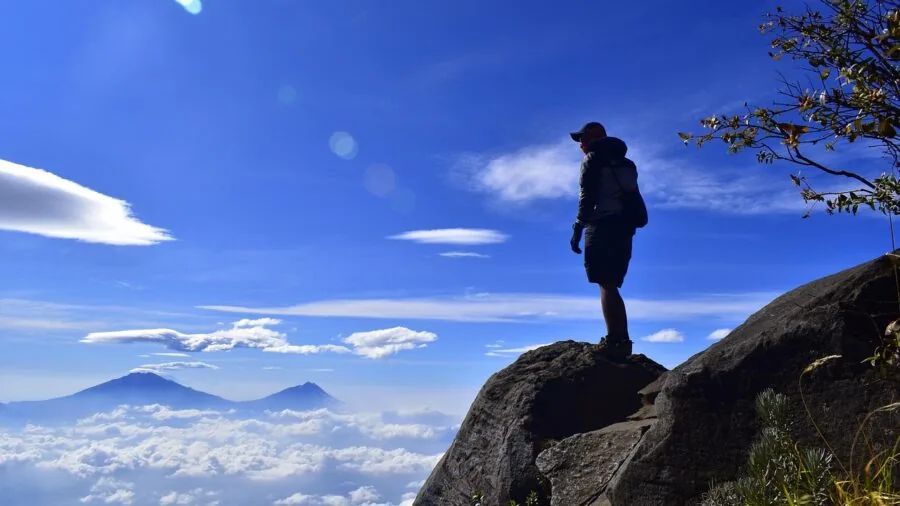 Hiker reviewing gear and supplies for backcountry camping adventure