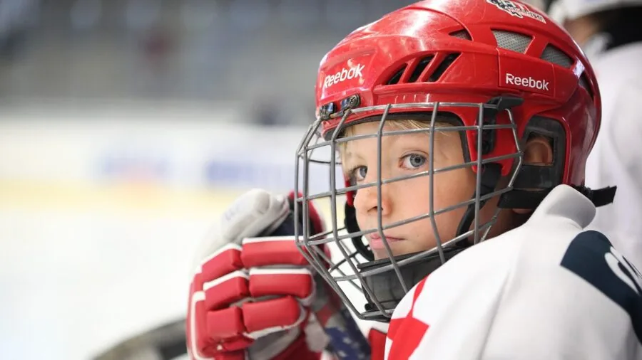 Hockey player demonstrating powerful skating technique and ankle control on ice rink during game