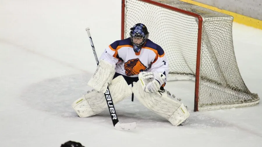 Hockey player demonstrating stick flexibility and body positioning during practice drill