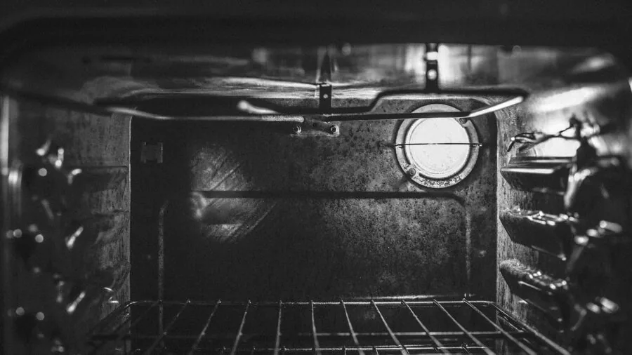 Home cook preparing food in modern kitchen with oven, demonstrating cooking versatility and technique