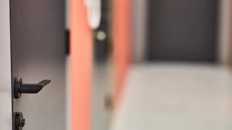 Homeowner installing a secure deadbolt lock on residential front door